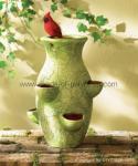 cardinal sits atop pocketed pot, poly resin pot,  resin pot